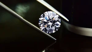 Inspecting a diamond held in tweezers, how valuable are diamonds and gemstones