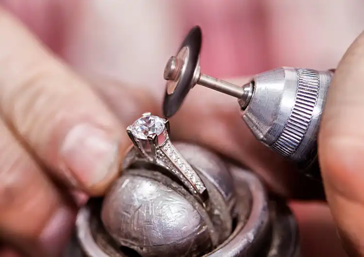 Craftsman making a fancy gold and diamond engagement ring