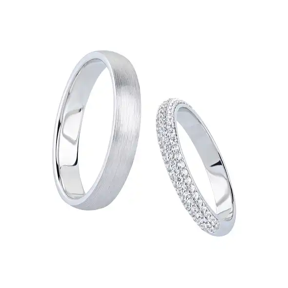A pair of silver wedding bands with diamonds