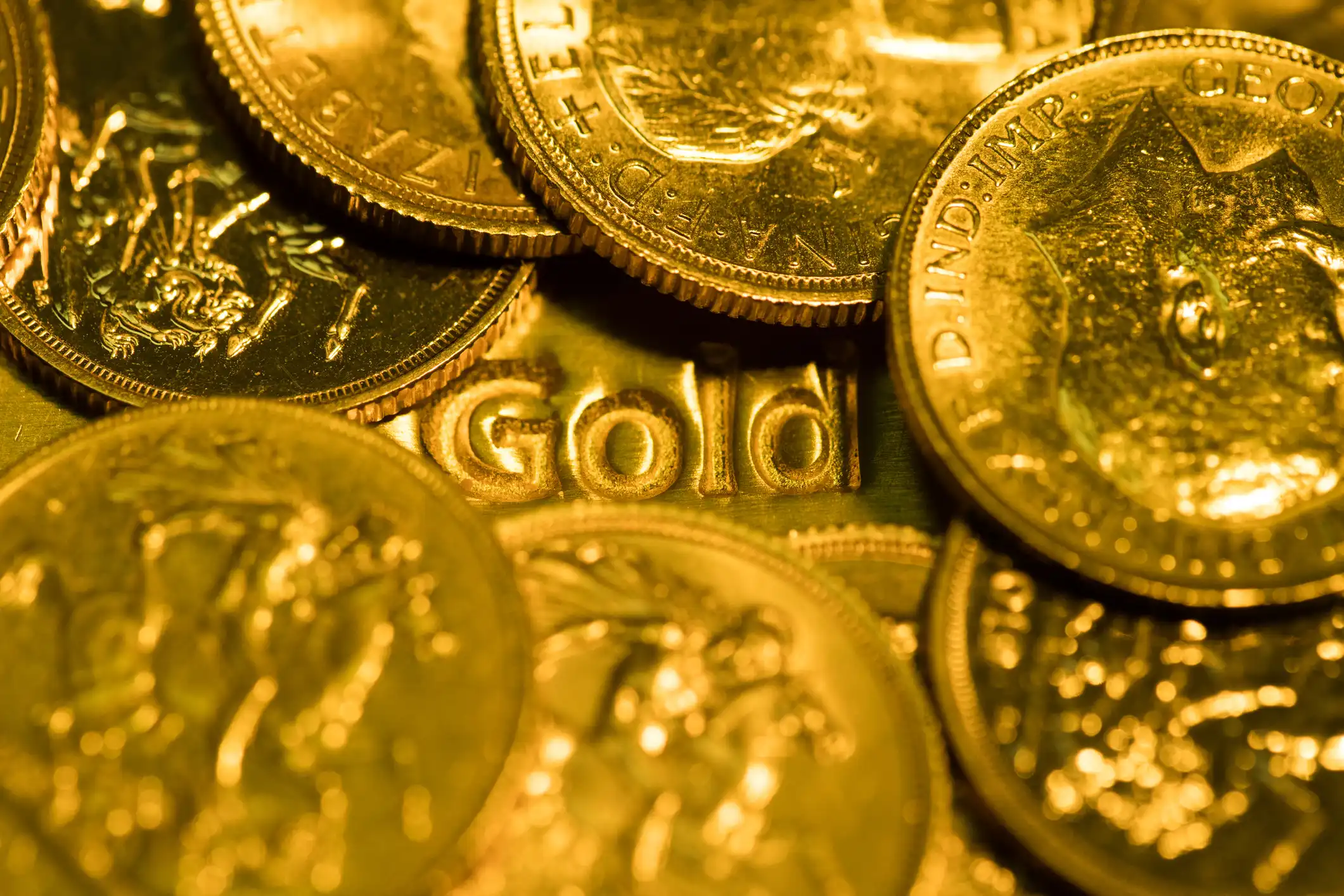 Gold bar in a pile of gold coins