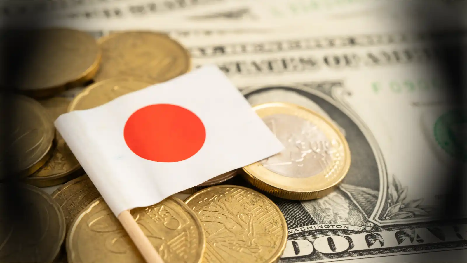 japanese flag sitting on a pile of money